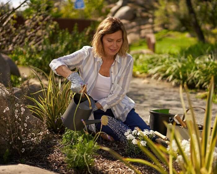 Woman gardening with water can