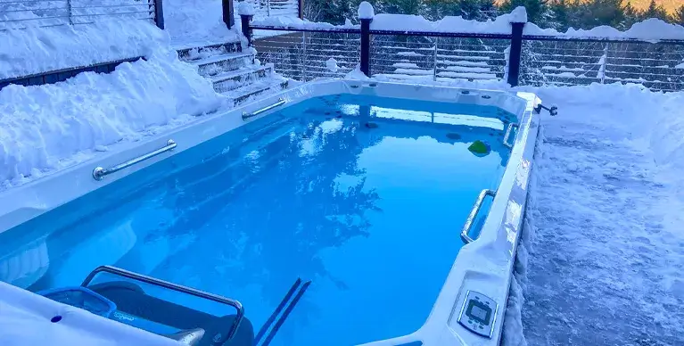 Swim spa in backyard in snow