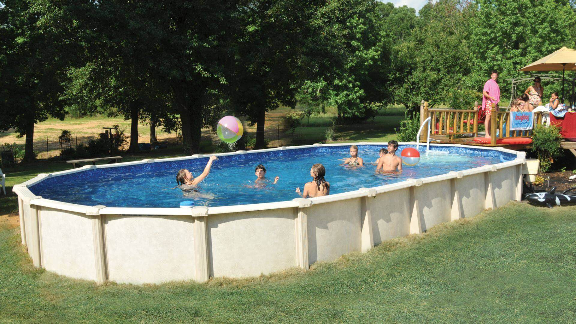 Doughboy Pool in backyard with kids playing inside and adults grilling on deck
