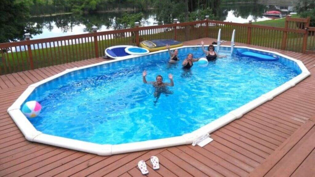 Family in above ground pool waving to the camera