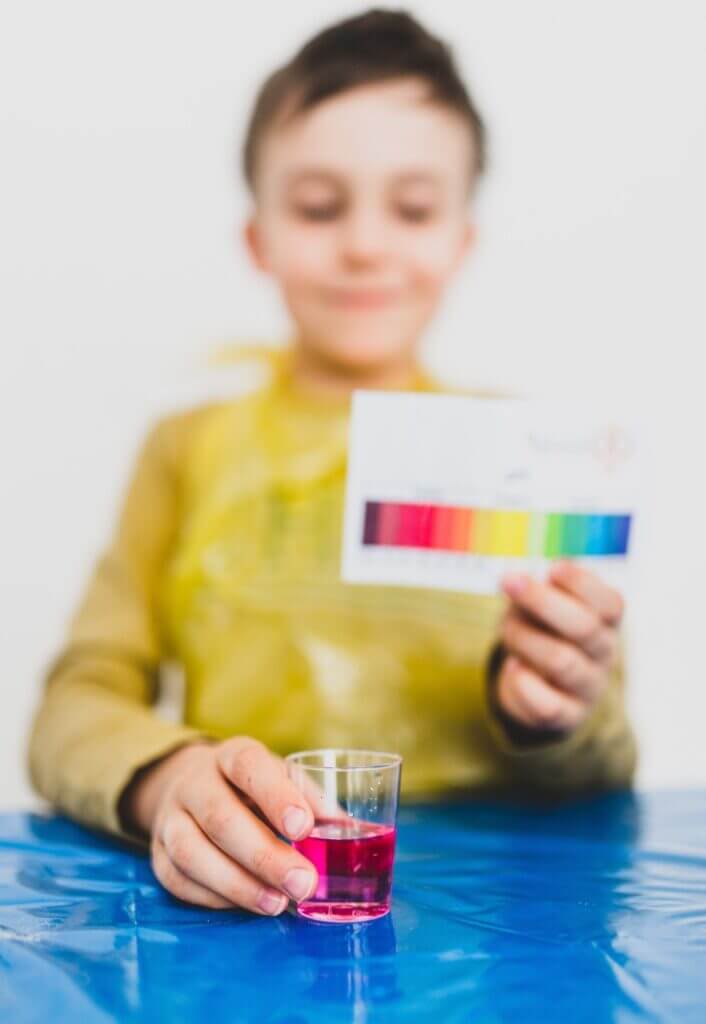 free water analysis shown by a boy holding a color test.
