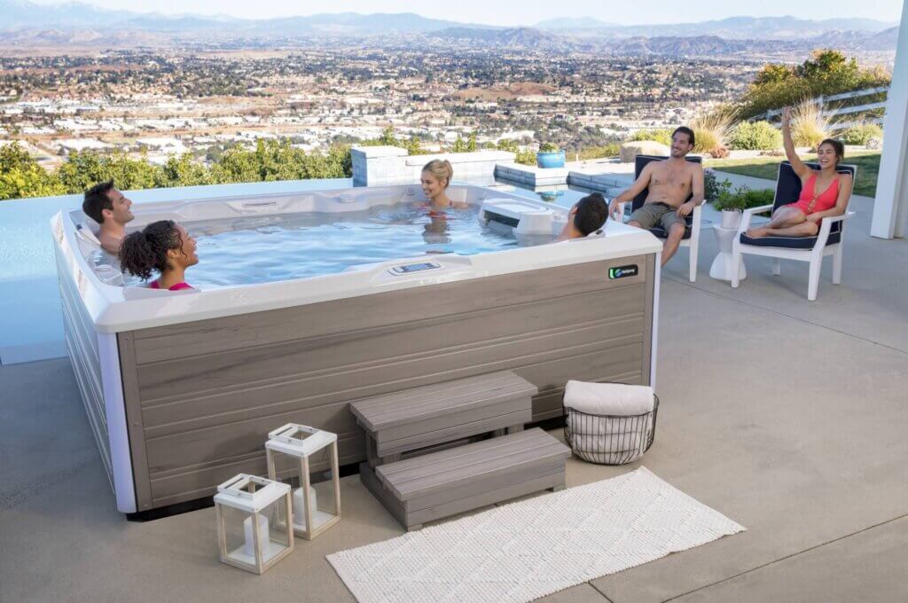 Hot Spring hot tub on a patio with family soaking