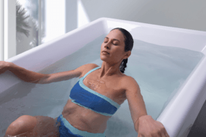 Person stepping into a Vigor cold plunge for post-workout recovery